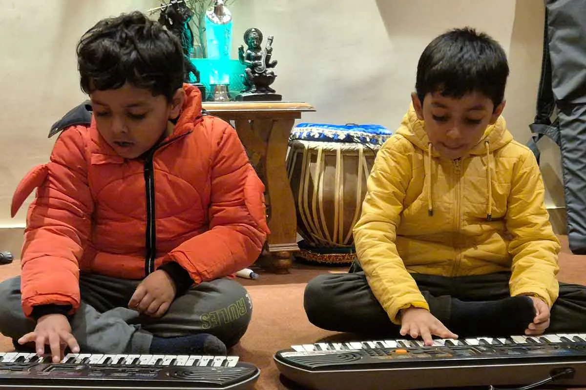 Children playing piano at Aalaap Music Academy Varanasi